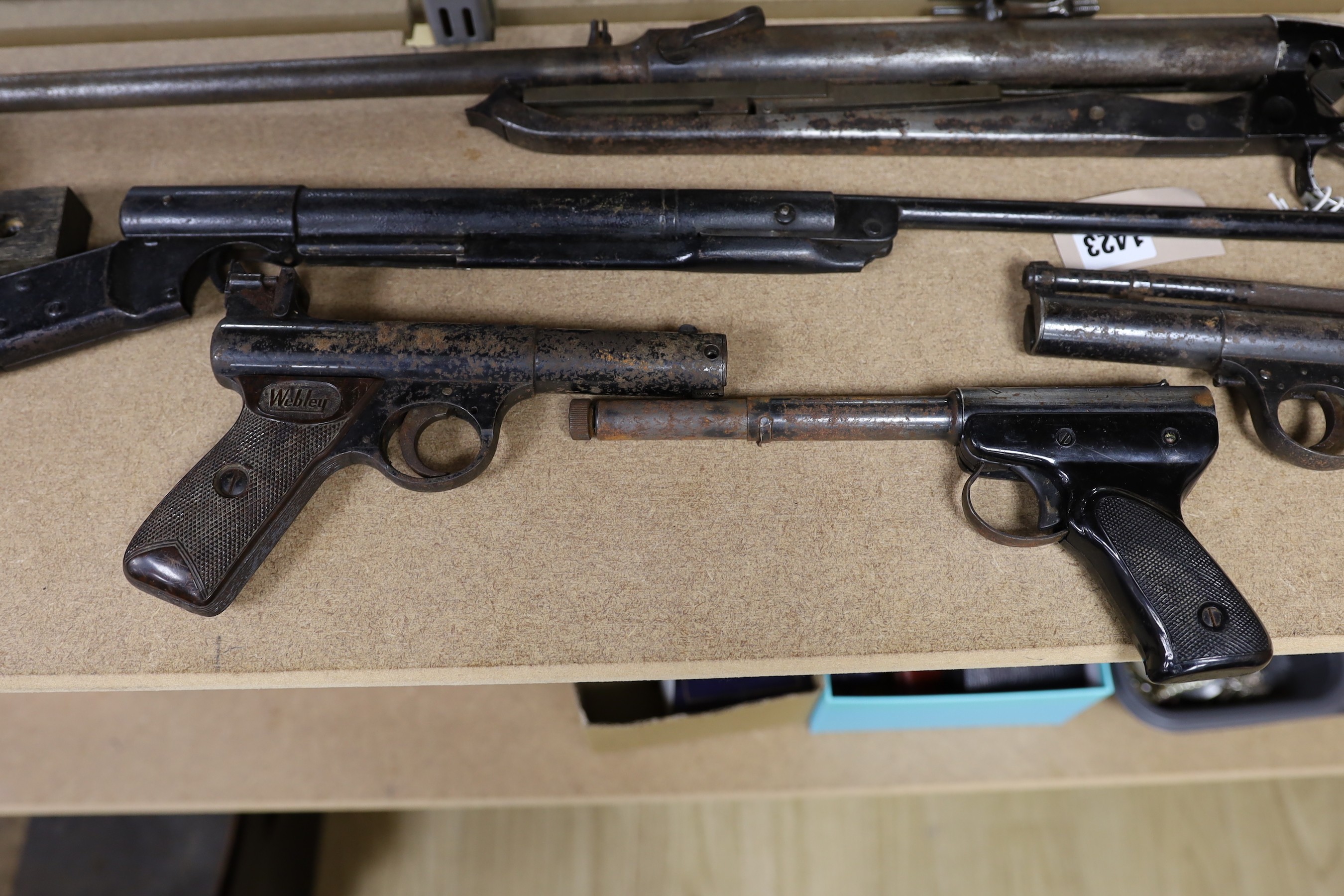 Two Webley air pistols, another, an air rifle and a part rifle